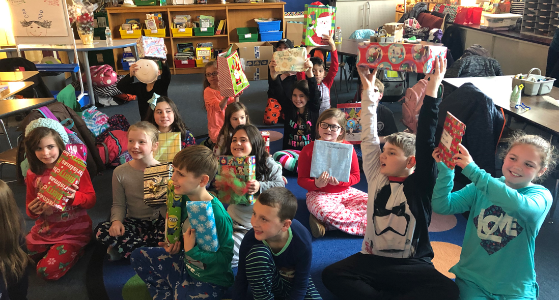 students-holding-up-gifts