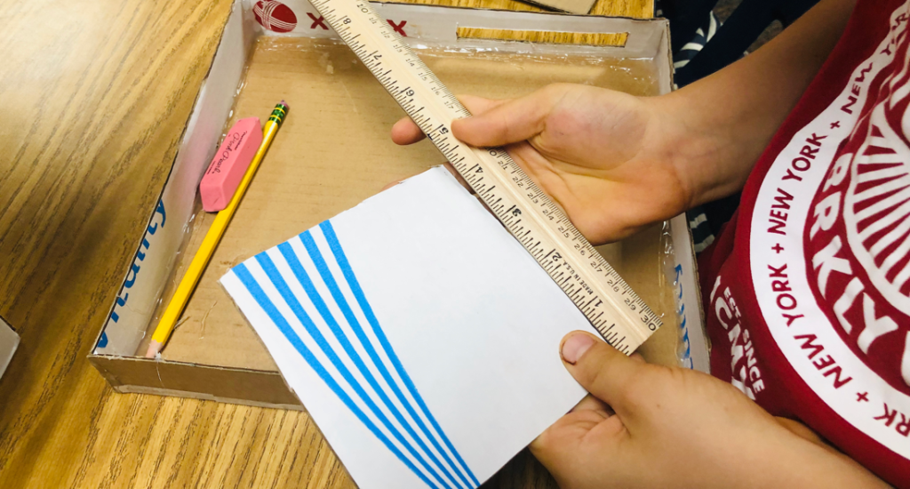 student-measuring-paper